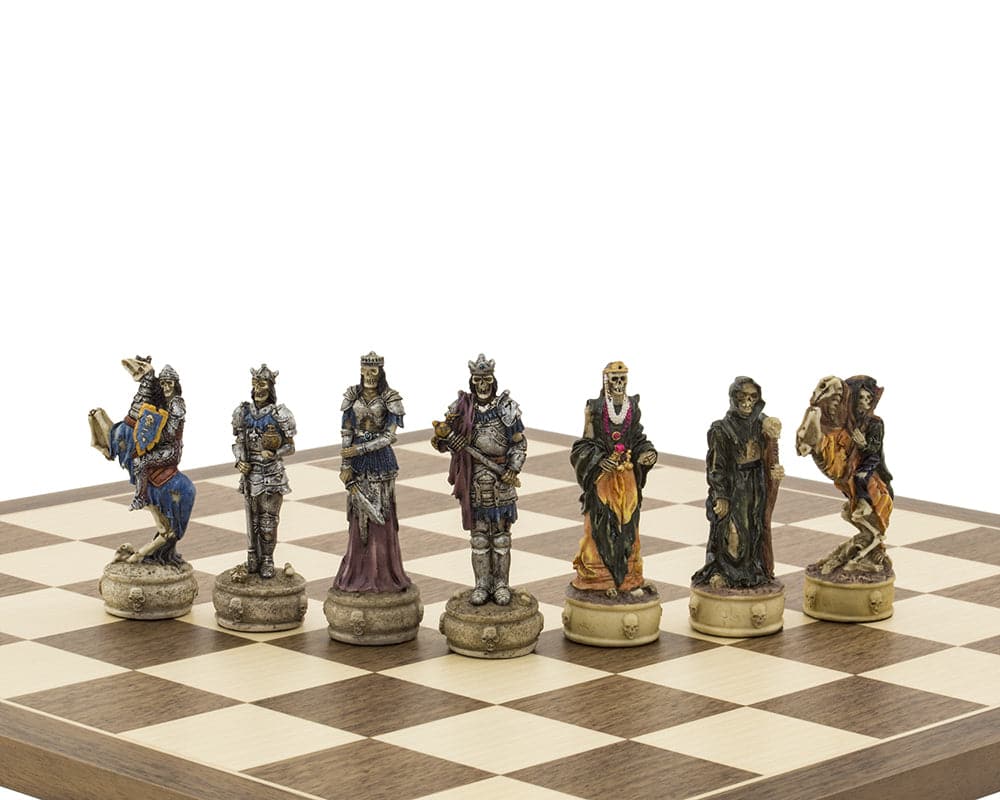 Zombie-themed hand-painted Italfama chess pieces on a chessboard, featuring ornate skeletal designs with blue, purple, and rustic hues.
