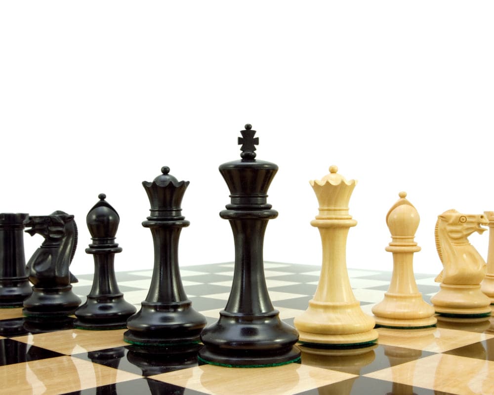 Old English Elite Series Ebony Staunton Chess Pieces 4 Inches set up on a chessboard with black and white pieces, featuring a 4 inch king.