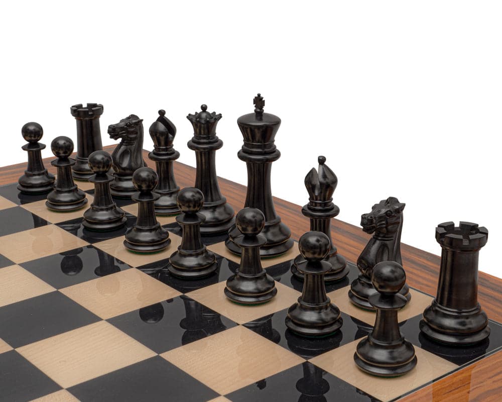 Handcrafted Staunton ebony chess pieces on chessboard with large squares, featuring detailed 4.4 inch king, 1849 model reproduction.