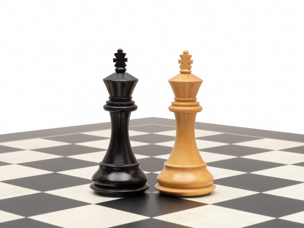 Ebonised 4 inch chess king pieces on a chessboard