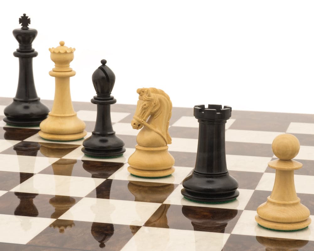 The Monarch Ebony And Walnut Grand Luxury Chess Set featuring elegant chess pieces on a polished chessboard.